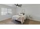 Bedroom with large window, decorative mirror, neutral tones and carpet at 13621 N 98Th Ave # E, Sun City, AZ 85351