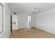 Empty bedroom with carpet, ensuite bath, fan and large window at 13621 N 98Th Ave # E, Sun City, AZ 85351