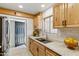 Updated kitchen with light wood cabinets, stainless steel appliances, and granite countertops at 13621 N 98Th Ave # E, Sun City, AZ 85351