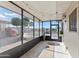 Bright screened porch with tile floor, offering a view of the landscaped yard at 13621 N 98Th Ave # E, Sun City, AZ 85351