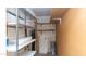 Storage area features metal shelving and a partially open wall with wooden shelves at 13621 N 98Th Ave # E, Sun City, AZ 85351
