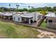 Aerial view of backyard featuring a covered patio, grill, artificial turf, and partial views of a golf course at 14247 N 2Nd Ave, Phoenix, AZ 85023