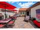 Inviting back patio with brick pavers, comfortable seating under red umbrellas, and great outdoor living space at 14247 N 2Nd Ave, Phoenix, AZ 85023