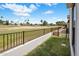 Well-maintained backyard with lush grass, a fence, and views of the golf course and palm trees at 14247 N 2Nd Ave, Phoenix, AZ 85023