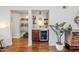 Home bar area with wine cooler, marble countertop, storage, and decorative shelving at 14247 N 2Nd Ave, Phoenix, AZ 85023