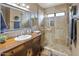 Elegant bathroom featuring a tiled shower with a glass door and a wood vanity with a decorative mirror at 14247 N 2Nd Ave, Phoenix, AZ 85023