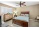 Inviting bedroom with carpet, wood furniture, shuttered window, and ceiling fan at 14247 N 2Nd Ave, Phoenix, AZ 85023