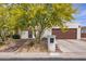 Charming home featuring a lush, flowering tree and a well-maintained two-car garage, and inviting curb appeal at 14247 N 2Nd Ave, Phoenix, AZ 85023