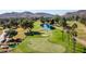 Scenic golf course view featuring lush green fairways, a tranquil pond, mature trees, and picturesque mountain views at 14247 N 2Nd Ave, Phoenix, AZ 85023