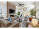 Comfortable living room featuring stone fireplace, large TV, leather sofas, and golf course views at 14247 N 2Nd Ave, Phoenix, AZ 85023