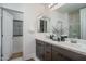 Well-lit bathroom featuring a double sink vanity, modern fixtures, and a glass-enclosed shower at 14870 W Encanto Blvd # 2123, Goodyear, AZ 85395