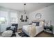 Inviting bedroom with modern decor, comfortable seating, plush bedding, and neutral color palette at 14870 W Encanto Blvd # 2123, Goodyear, AZ 85395