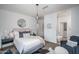 Well-lit bedroom with en suite bathroom access featuring modern furnishings, and minimalist decor at 14870 W Encanto Blvd # 2123, Goodyear, AZ 85395