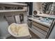 Bright walk-in closet featuring a vanity area, shelving, drawers and chair at 14870 W Encanto Blvd # 2123, Goodyear, AZ 85395