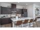 Modern kitchen with dark wood cabinetry and a large central island at 14870 W Encanto Blvd # 2123, Goodyear, AZ 85395