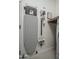 A well-organized laundry room featuring an ironing board, vacuum cleaner, and built-in shelving at 14870 W Encanto Blvd # 2123, Goodyear, AZ 85395