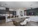 Open-concept living space with modern kitchen, dining area, and stylish furnishings under recessed and chandelier lighting at 14870 W Encanto Blvd # 2123, Goodyear, AZ 85395