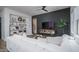 Cozy living room featuring a plush white sofa, dark accent wall, built-in shelving, and contemporary decor at 14870 W Encanto Blvd # 2123, Goodyear, AZ 85395