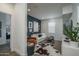 Comfortable living room with stylish decor, a cowhide rug, a navy accent wall, and modern furnishings at 14870 W Encanto Blvd # 2123, Goodyear, AZ 85395
