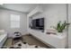 Sleek living room featuring modern white furniture, minimalist decor, contemporary art, and neutral color palette at 14870 W Encanto Blvd # 2123, Goodyear, AZ 85395