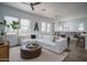 Bright living room with a large sectional sofa, modern furniture, and lots of natural light streaming through the windows at 14870 W Encanto Blvd # 2123, Goodyear, AZ 85395