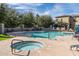 Inviting community pool with a jacuzzi, surrounded by comfortable lounge areas and lush greenery at 14870 W Encanto Blvd # 2123, Goodyear, AZ 85395
