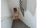 Modern staircase featuring neutral carpet, white walls, and decorative wall hangings at 14870 W Encanto Blvd # 2123, Goodyear, AZ 85395