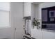 Modern, built-in storage unit with open closet, minimalist design, and neutral colors at 14870 W Encanto Blvd # 2123, Goodyear, AZ 85395