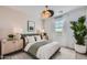 A bedroom with an olive green bedframe, neutral walls, and light wood nightstands create a calming and inviting space at 15782 W Kendall St, Goodyear, AZ 85338
