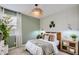This bedroom features decor lighting, neutral tones, and natural light through the window at 15782 W Kendall St, Goodyear, AZ 85338