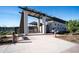 Inviting clubhouse entrance with modern architecture, a shaded pergola, and well-maintained landscaping at 15782 W Kendall St, Goodyear, AZ 85338