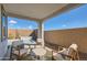 Cozy covered patio with outdoor seating area overlooking a private backyard and water feature at 15782 W Kendall St, Goodyear, AZ 85338