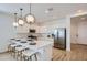 Modern white kitchen featuring a spacious island, stainless steel appliances, and pendant lighting at 15782 W Kendall St, Goodyear, AZ 85338