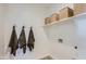A laundry room with plenty of storage and hooks for the towels to hang at 15782 W Kendall St, Goodyear, AZ 85338