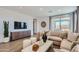 Cozy living room with modern furnishings, neutral colors, and large windows to let in natural light at 15782 W Kendall St, Goodyear, AZ 85338