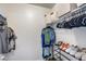 Well-organized walk-in closet with shelving and hanging space for clothes and accessories at 16103 W Redfield Rd, Surprise, AZ 85379