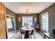 A cozy dining room with a round table set for four, complemented by stylish decor and soft natural light at 16103 W Redfield Rd, Surprise, AZ 85379