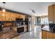 Well-lit kitchen featuring wood cabinets, stainless steel appliances, granite counters, and tile flooring at 16103 W Redfield Rd, Surprise, AZ 85379