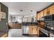 Open concept kitchen features stainless steel appliances, granite countertops, and wood cabinets at 16103 W Redfield Rd, Surprise, AZ 85379