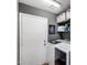 A functional laundry area with modern washer and dryer units and storage shelves for supplies at 16103 W Redfield Rd, Surprise, AZ 85379