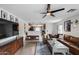 Bright living room featuring tile floors, ceiling fan, and comfortable leather seating at 16103 W Redfield Rd, Surprise, AZ 85379