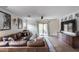 Bright living room featuring tile floors, ceiling fan, and comfortable leather seating at 16103 W Redfield Rd, Surprise, AZ 85379
