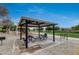 Community picnic area with tables, shade, playground, and barbecue at 16103 W Redfield Rd, Surprise, AZ 85379
