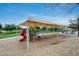 Community playground featuring slides, swings, and covered picnic tables at 16103 W Redfield Rd, Surprise, AZ 85379