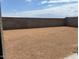 Unfinished backyard is ready for landscaping or customization at 17409 W Eva St, Waddell, AZ 85355