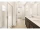 Bathroom with a double vanity, walk-in shower, and window at 17409 W Eva St, Waddell, AZ 85355