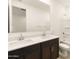 Bathroom features dual sinks, a large mirror, and a shower over tub at 17409 W Eva St, Waddell, AZ 85355