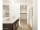 Bathroom featuring a double vanity, walk-in shower, and wood-style flooring at 17409 W Eva St, Waddell, AZ 85355
