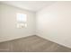 Cozy bedroom features neutral carpet, a bright window, and ample natural light at 17409 W Eva St, Waddell, AZ 85355