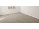 Bright bedroom with neutral carpet, a window, and plenty of space at 17409 W Eva St, Waddell, AZ 85355